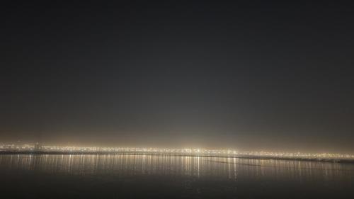 a large body of water with a city in the background at Prayagraj Sangam Homestays in Naini