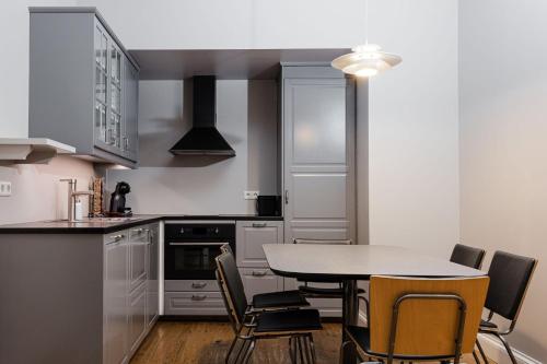 a kitchen with a table and chairs in it at Reykjavik Residence Apartment Hotel in Reykjavík