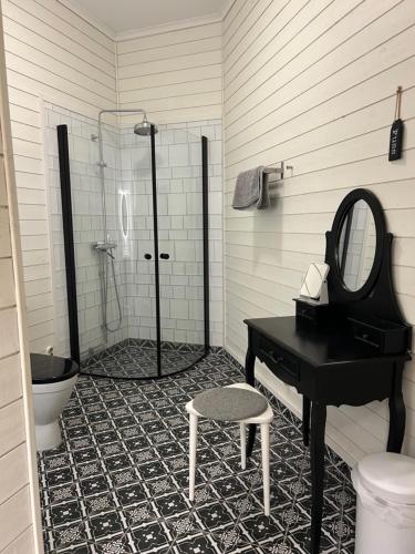 a bathroom with a sink and a mirror and a piano at Bashults Gård in Jönköping