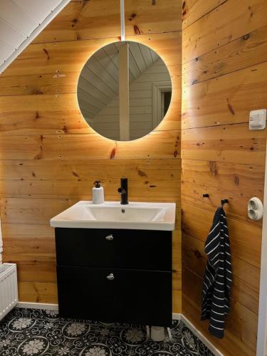 a bathroom with a sink and a mirror at Bashults Gård in Jönköping
