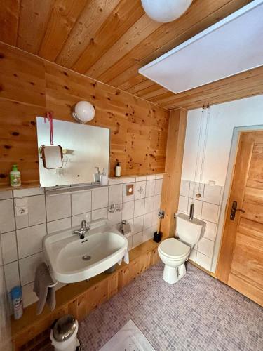 a bathroom with a white sink and a toilet at Ferienhaus Marie in Tux