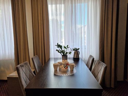 a dining room table with chairs and a table with food on it at Boutique Hotel's Bytom in Bytom