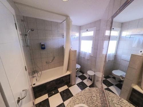 a bathroom with a shower and a toilet and a sink at Club Hotel Drago Park in Costa Calma