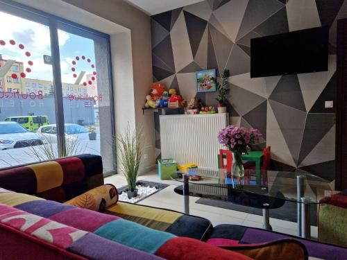 a living room with a couch and a tv at Boutique Hotel's Bytom in Bytom