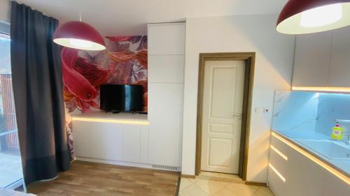 a hallway with a room with a television and a door at Свети Йоан in Sozopol