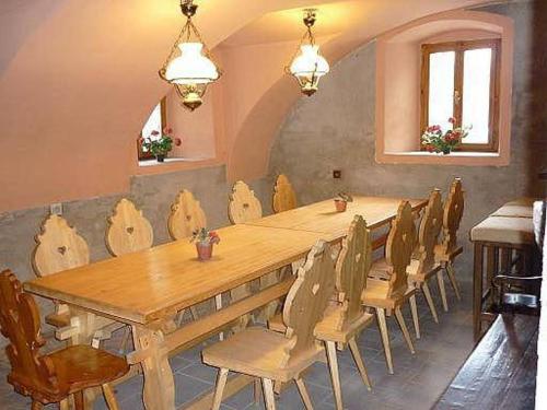 a long wooden table and chairs in a room at Chalupa Pod Návsí - Olešnice v Orlických horách in Olešnice v Orlických horách