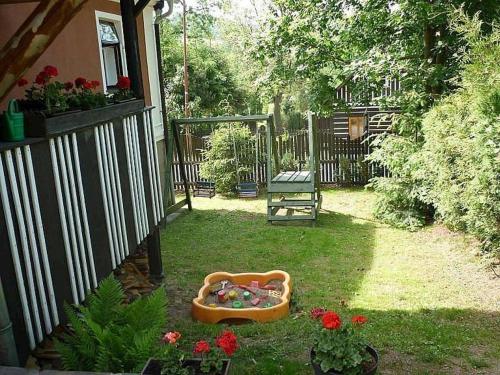 a backyard with a dog bed in the grass at Chalupa Pod Návsí - Olešnice v Orlických horách in Olešnice v Orlických horách