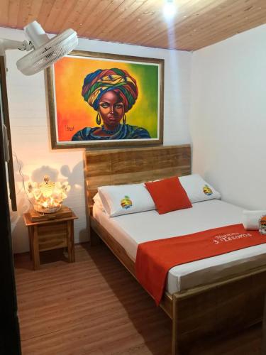 a bedroom with a bed with a painting on the wall at Nuestros Tres Tesoros II in Playa Blanca