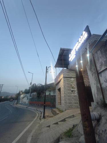 a building with lights on the side of a street at Jammu Ala Guest house in Jammu