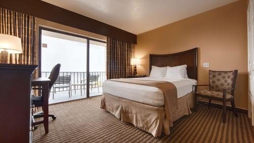 a hotel room with a bed and a balcony at Best Western Fort Myers Waterfront in North Fort Myers