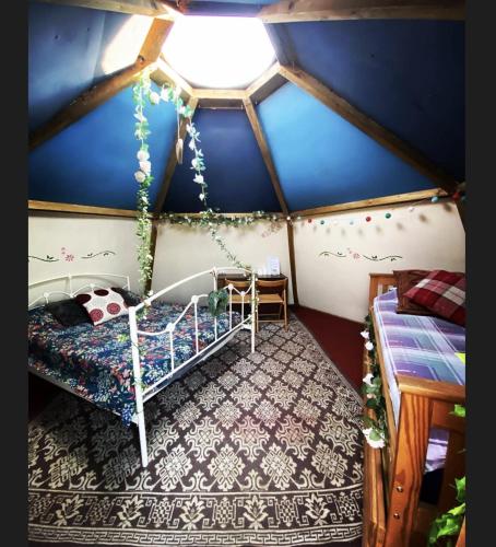 a room with a bed and a blue wall at daisy meadow in Upton upon Severn