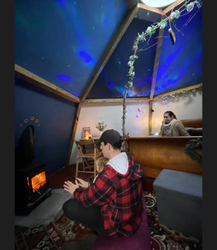 a man and a child in a room in a tent at daisy meadow in Upton upon Severn