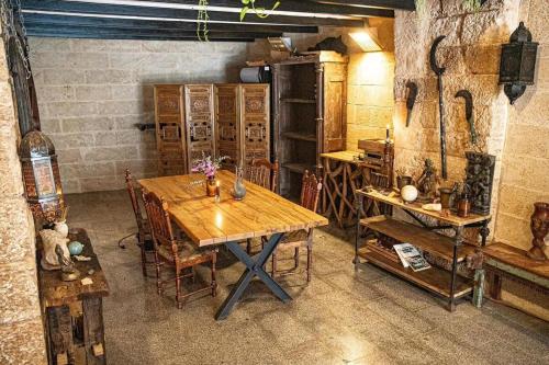 a room with a wooden table and chairs and an oven at The Temple Jaffa in Tel Aviv