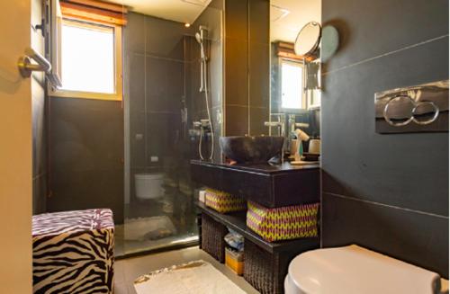 a bathroom with a sink and a toilet in it at Casa Onix Ibiza in Ibiza Town