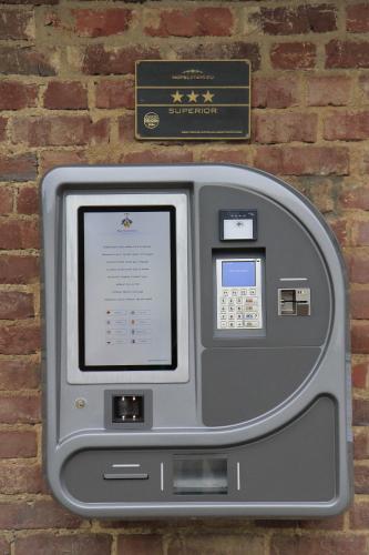 an atm machine sitting on top of a brick wall at Burg Heimerzheim in Swisttal