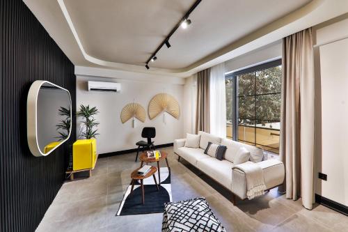 a living room with a couch and a mirror at Luff Boutique Hotel - Adult Only in Kas