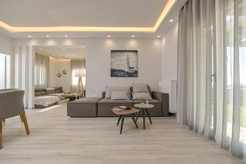 a living room with a couch and a table at Villa Bazeos in Agkidia