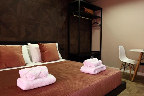 two towels on top of a bed in a room at Spera Luxury Palermo & SPA in Palermo
