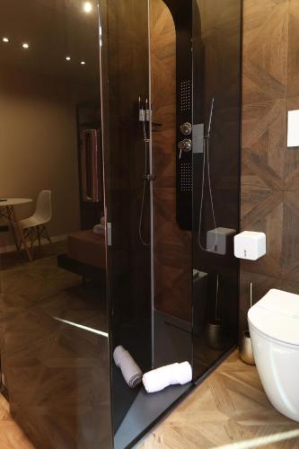 a bathroom with a shower and a toilet at Spera Luxury Palermo & SPA in Palermo