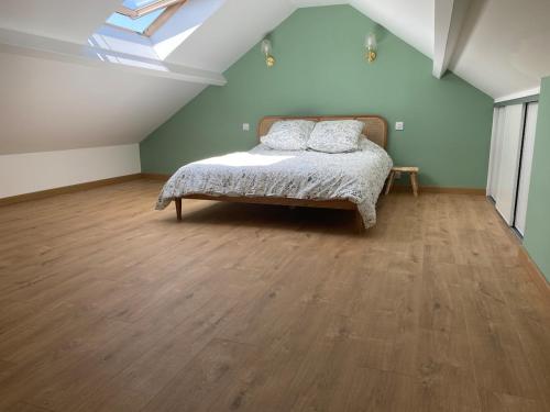 a bedroom with a bed with two pillows on it at Petite maison proche plage in Ouistreham