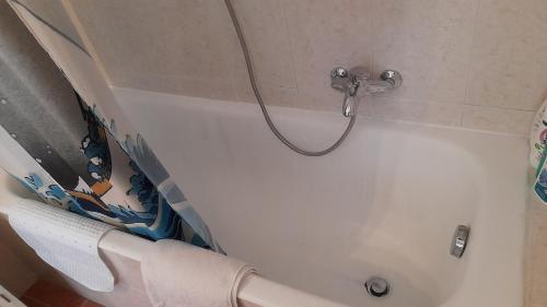 a white bath tub with a hose in a bathroom at Entire apartment in Panoramic Villa with Bathtub in Colleverde