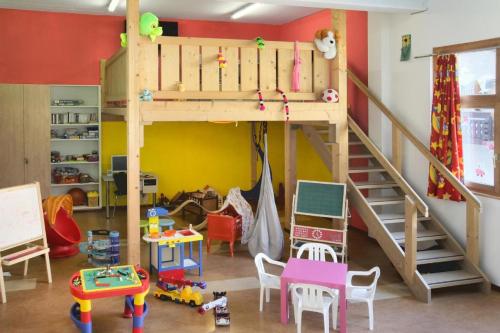 a play room with a loft bed and lots of toys at Appartement Flora in Saas-Almagell