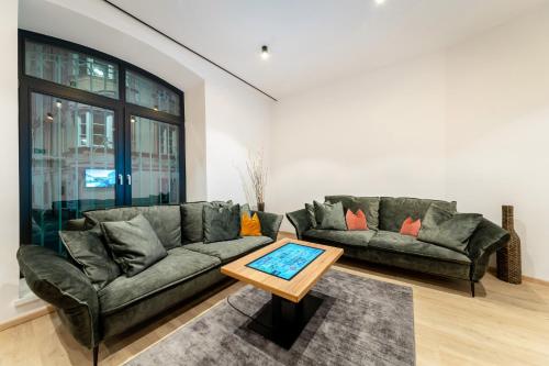 a living room with a couch and a table at Das Sill by Inncomer in Innsbruck