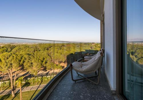 a room with a chair on a balcony with a view at Ethno Belek in Belek