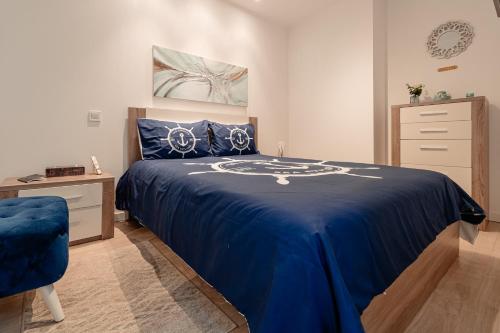 a bedroom with a blue bed and a dresser at Seixal Yachting Bay Original in Seixal