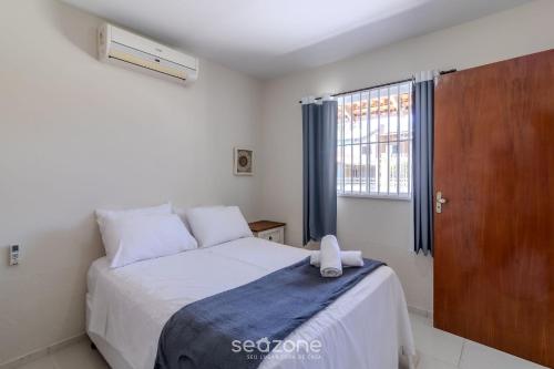 Ένα ή περισσότερα κρεβάτια σε δωμάτιο στο Casa 3Q Piscina e Churrasq. 500m da praia RUA0226