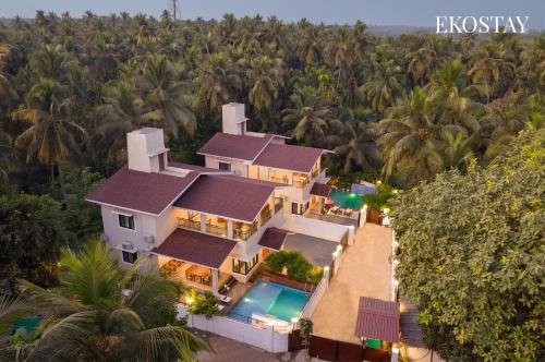 an aerial view of a house with a swimming pool at EKOSTAY - Mercury Villa in Alibaug