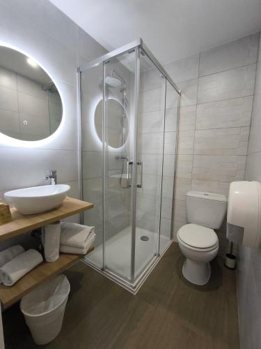 a bathroom with a shower and a toilet and a sink at Hotel Saint Gothard in Nice