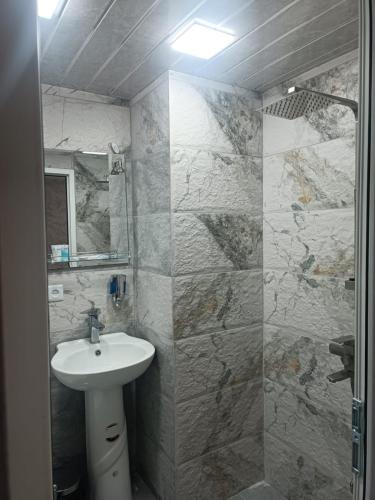 a bathroom with a sink and a mirror at Tevosyan Pluse Evn Airport in Pʼarakʼar