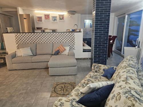 a living room with two couches and a couch at Mare e cielo in Porticello