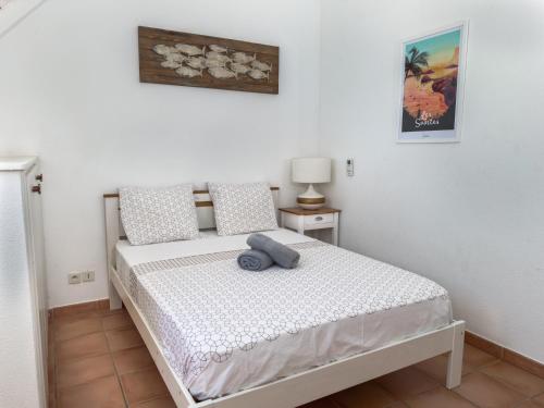 a bedroom with a bed with a blue towel on it at villa Caraibes proche plage in Sainte-Anne