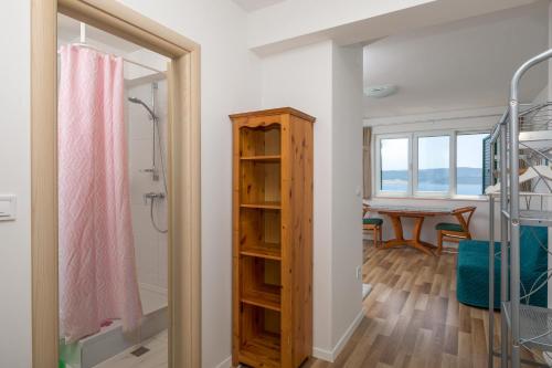 a bathroom with a walk in shower and a table at Apartmani Noah - Mia in Celina