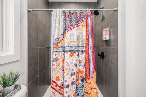 a shower with a shower curtain in a bathroom at Jude's Respite in Traverse City
