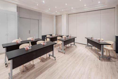 a row of tables in a room with chairs at Hotel Madrid Alameda Aeropuerto, Affiliated by Meliá in Madrid