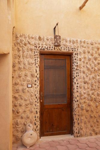 a wooden door in the side of a building at People to People Siwa in Siwa
