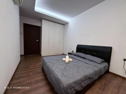 a bedroom with a bed with a stuffed animal on it at Vivacity Jazz Suites Kuching by REA Homestay in Kuching