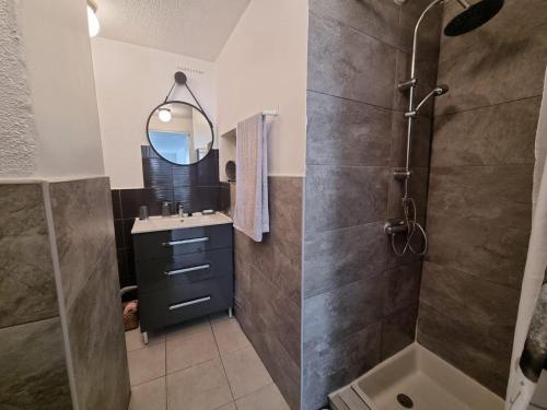 une salle de bain avec une douche, un lavabo et un miroir dans l'établissement T2 Marseille Panier Vieux Port, à Marseille