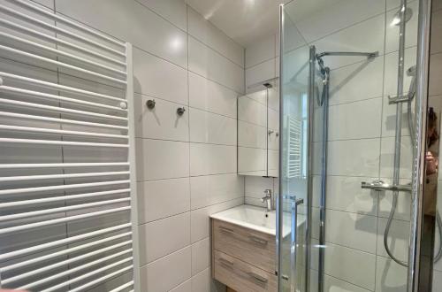 a bathroom with a glass shower and a sink at Schorrebloem 9* in Nieuwvliet