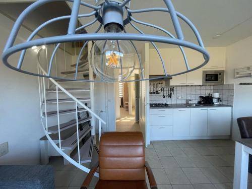 a chandelier in the middle of a kitchen at Schorrebloem 9* in Nieuwvliet
