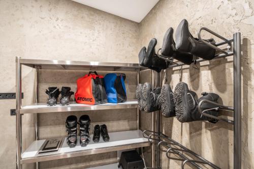 a shelf with shoes and other shoes on it at RONI Apartments Krkonoše in Cerny Dul