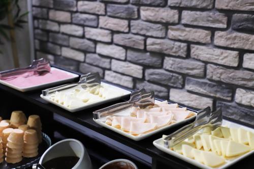 a table with several trays of cheese and other desserts at MYWAY DELUXE Alsancak in Konak