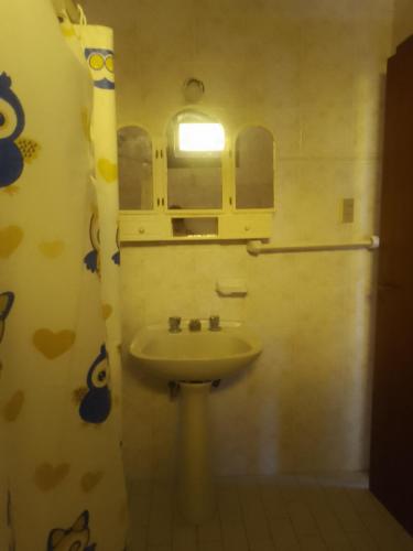 a bathroom with a sink and a window at Casa chalet neco in Necochea