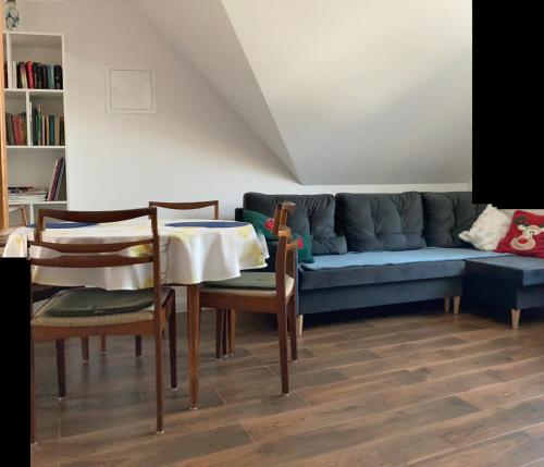 a living room with a couch and a table and chairs at Agroturystyka u Sylwii in Majdan Sopocki