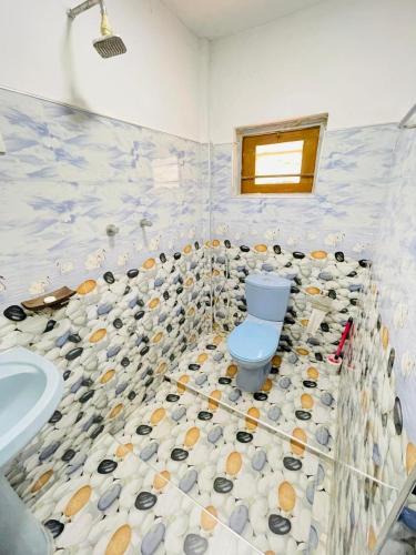 a bathroom with a toilet and a sink at Oasis Lagoon Garden in Tangalle