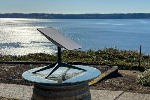 a glass sculpture on top of a barrel with a view of the water at Sunset Studio in Tyee Beach