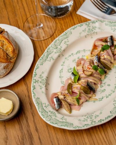 a plate of food on a table with bread at La Fantaisie in Paris